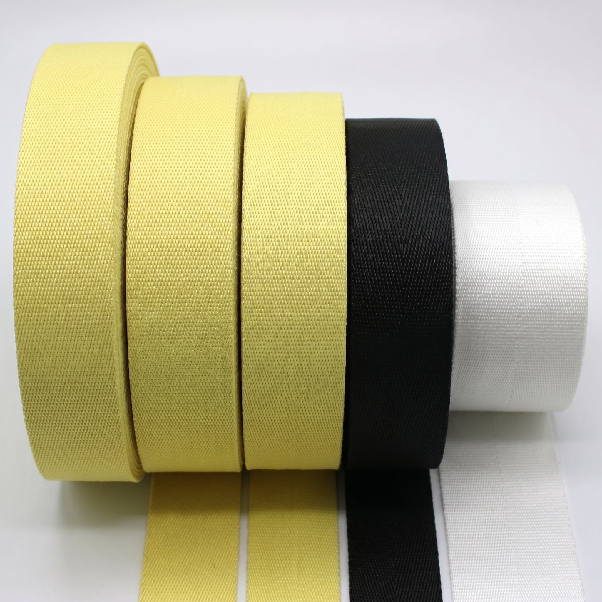 Yellow, white, and black high-performance woven fabric rolls and swatches